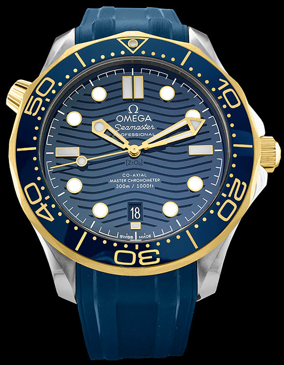 42mm- This watch has a stainless steel case with a blue ceramic and 18kt yellow Ceragold ™ rotating bezel. There is a blue ceramic dial under the domed sapphire crystal. The dial features a modern update to the laser engraved wave pattern made iconic by the original Diver 300m in 1993. The yellow gold skeleton hands and hour markers are filled with Super-LumiNova. The date can be viewed at the 6 o’clock position.
