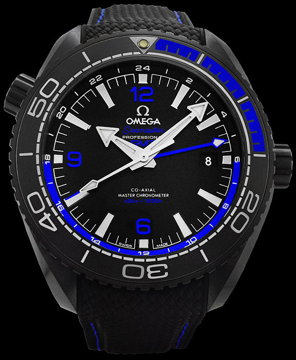 45.5mm -This matte black case was crafted from a single block of ceramic. Both rubber and “Liquidmetal” are used one the black ceramic bezel. The dial is also black ceramic with the date at the 6 o’clock position. The hands and indexes are 18kt white gold with a coating of Super Luminova. This watch features the Omega 8906 self winding movement with Co-Axial escapement. This watch features two barrels and a silicon balance spring. The movement can be viewed through the transparent screw in caseback.