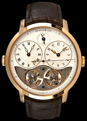 This piece has an 18kt rose gold case featuring two crowns on either side of the case, operating the two separate time displays. There is a sapphire crystal over the silver and open worked dial. The displays two time zones, one at the 3 o’clock and one at the 9 o’clock, as well as sweeping central seconds, and a day/night indicator at the 12 o’clock position.