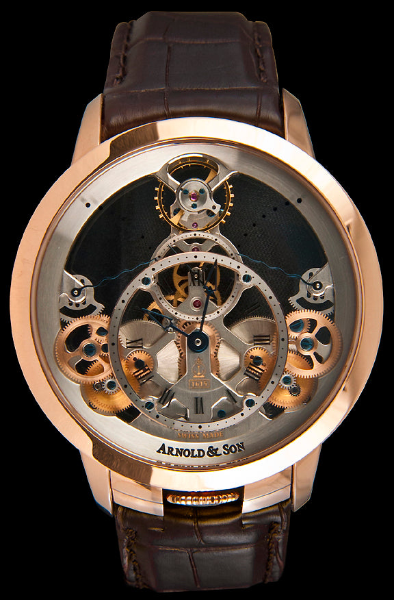 With a case crafted from 18kt red gold, this watch has a sapphire crystal over the fully skeletonized movement. The caseback is also sapphire crystal and both sides have been coated with an anti-glare treatment. The movement is pyramid shaped and displays two power reserve indicators at the 10 and 2 o’clock positions. In the center, the hours and minutes are displayed on a circular dial frame. Behind that is a second dial frame that displays the small seconds.