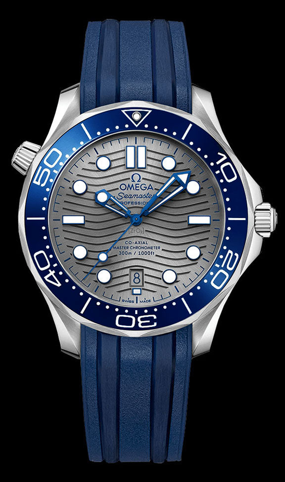 42mm – This watch has a stainless steel case with a blue ceramic rotating bezel. The diving scale on the bezel is crafted with enamel. There is a grey ceramic dial under the domed sapphire crystal. The dial features a modern update to the laser engraved wave pattern made iconic by the original Diver 300m in 1993. The skeleton hands and hour markers are rhodium plated and filled with Super-LumiNova.