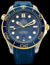42mm- This watch has a stainless steel case with a blue ceramic and 18kt yellow Ceragold ™ rotating bezel. There is a blue ceramic dial under the domed sapphire crystal. The dial features a modern update to the laser engraved wave pattern made iconic by the original Diver 300m in 1993. The yellow gold skeleton hands and hour markers are filled with Super-LumiNova. The date can be viewed at the 6 o’clock position. 